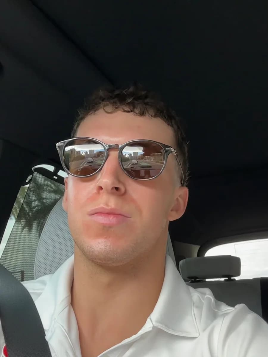 Hayden Mitchell between homeowner appointments in the car he used as his office during two years of in-home sales.
